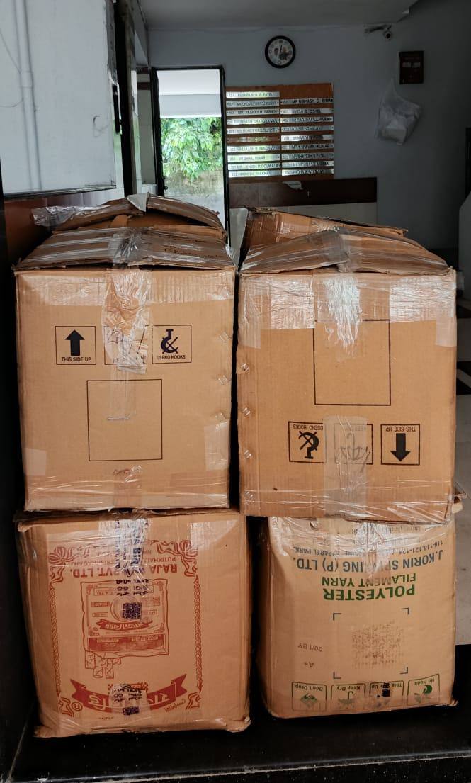 Packed moving boxes staged at the doorway for office shifting in Surat
